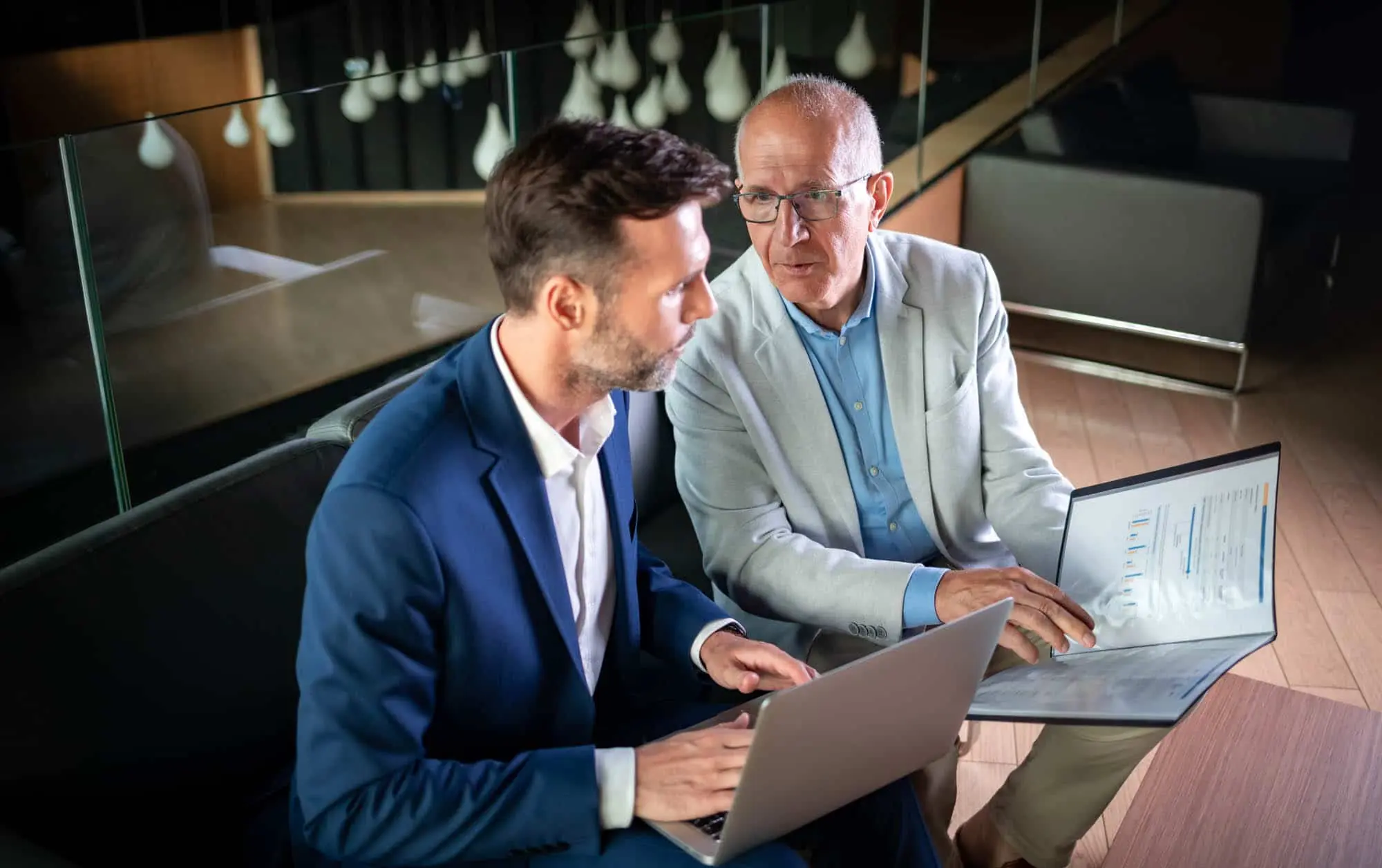 Photo of older man pointing out a report to younger man, Healthtech Resources, Inc. Healthcare IT, Phoenix, AZ